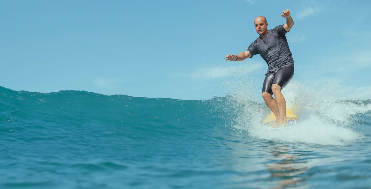 Surfer in longboard making an hang ten