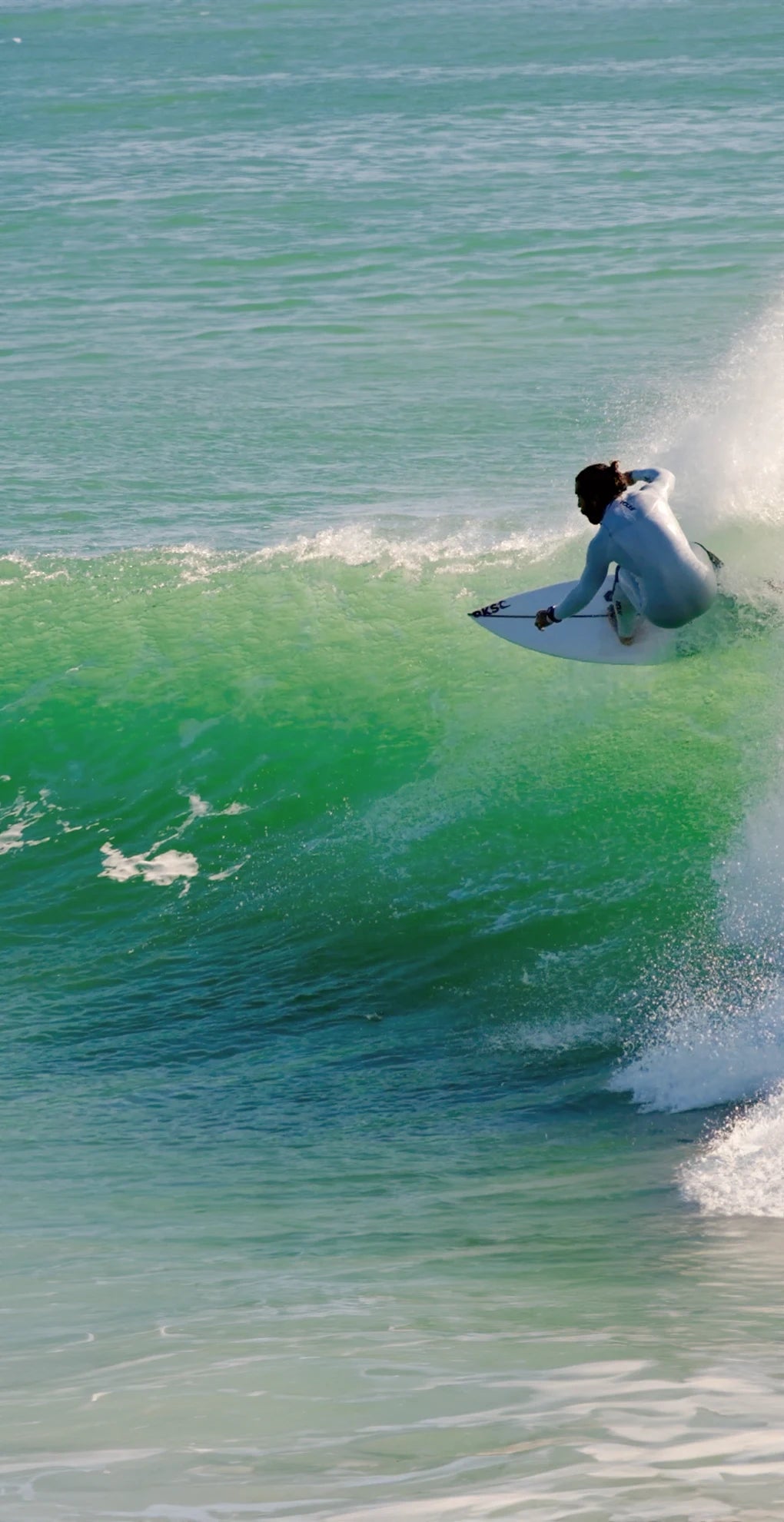 A person surfing with front foot traction pads