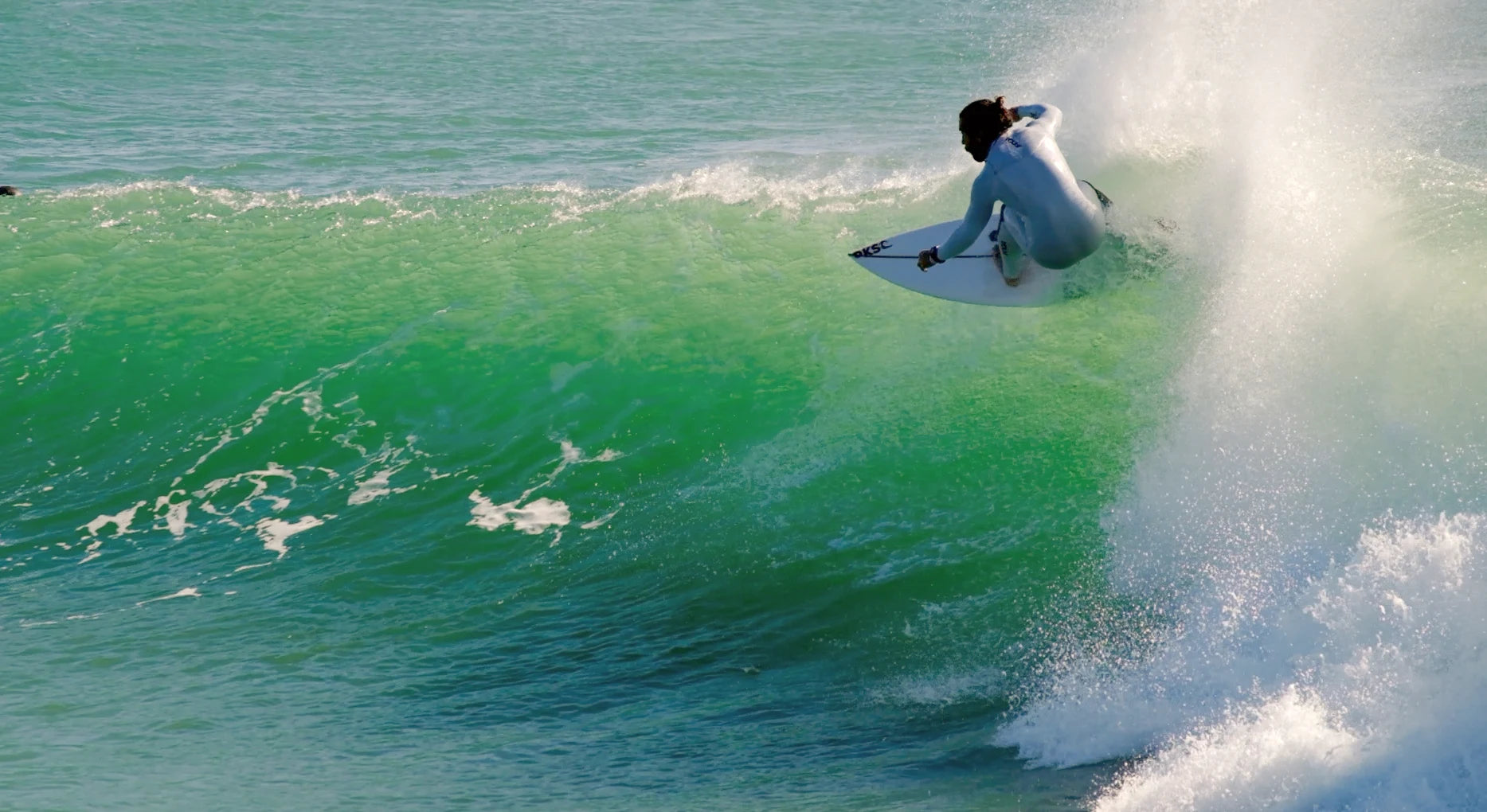 A person surfing with front foot traction pads