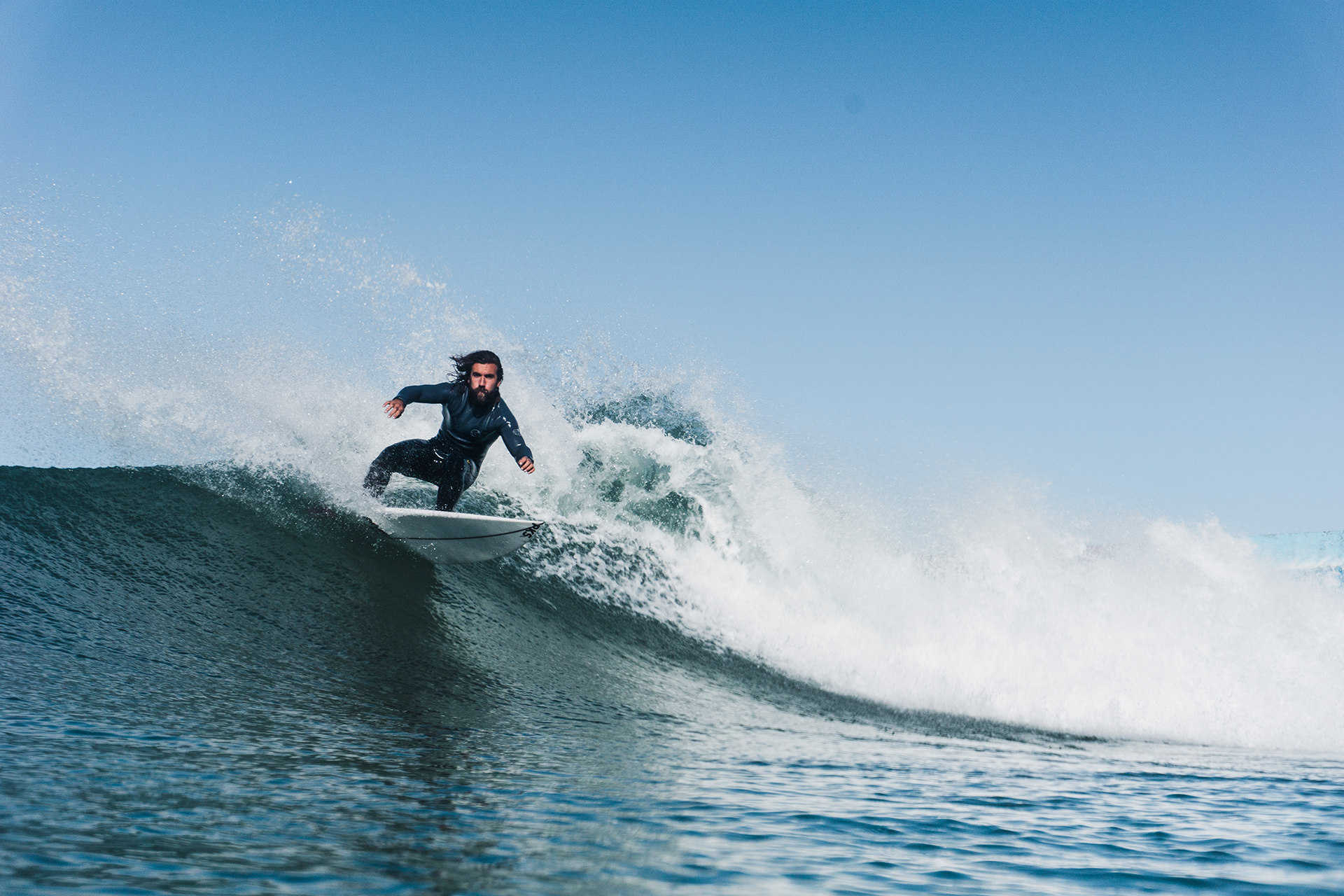 Person surfing on a wave with an alternative to surf wax